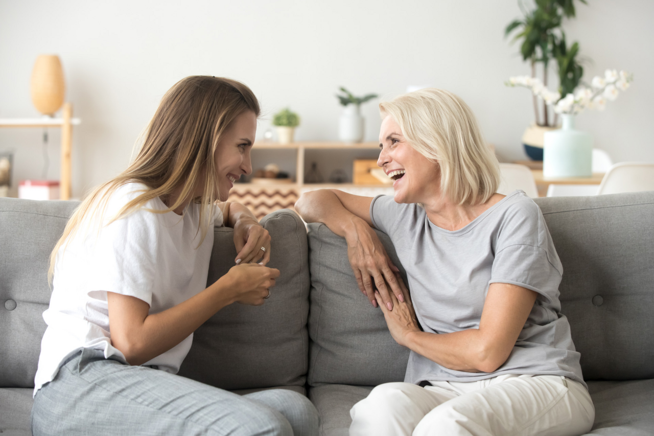 ph-pic-mother-young-adult-woman-talking-sofa-1231591396-ne